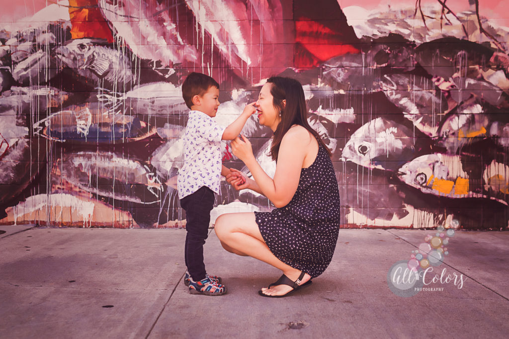 Mom and son playing in front of a San Diego Mural by Fintan Magee.