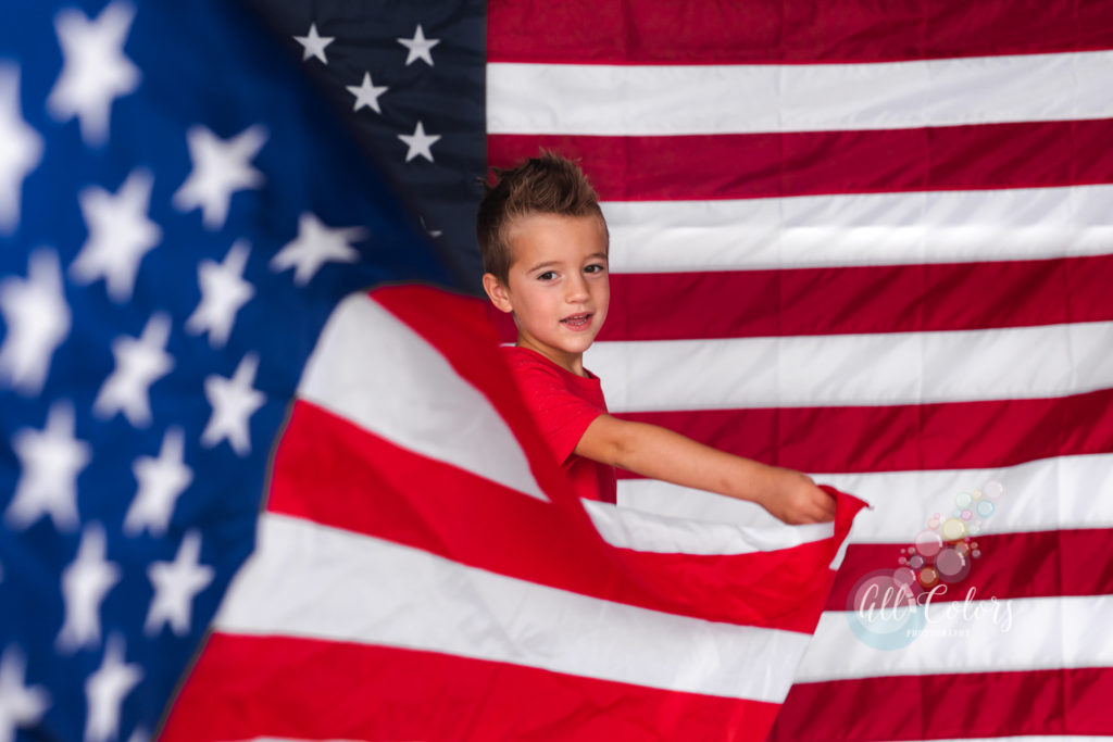boy holding an american flag