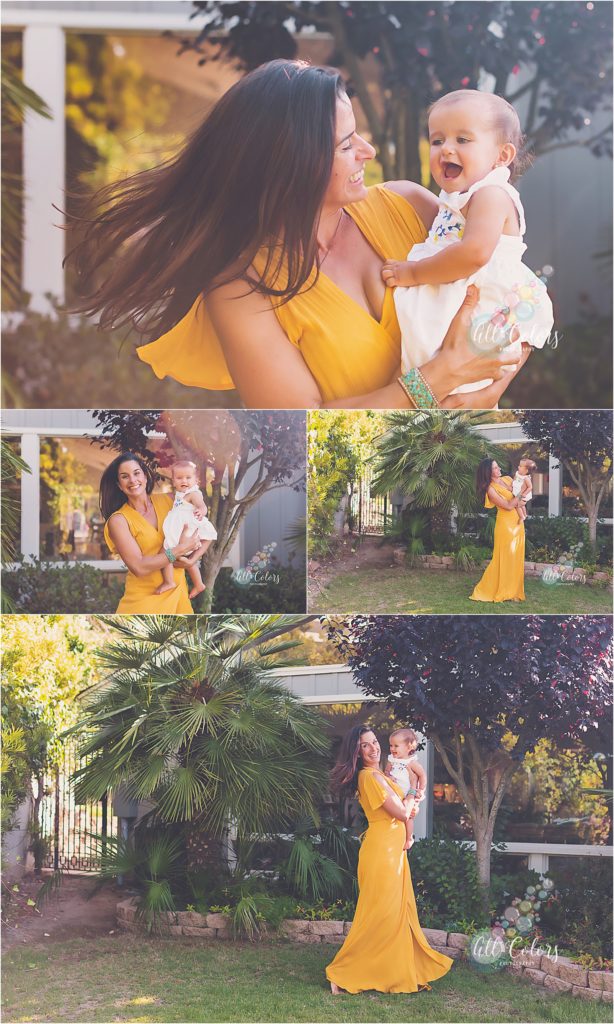 mom wearing a yellow dress playing with baby daughter