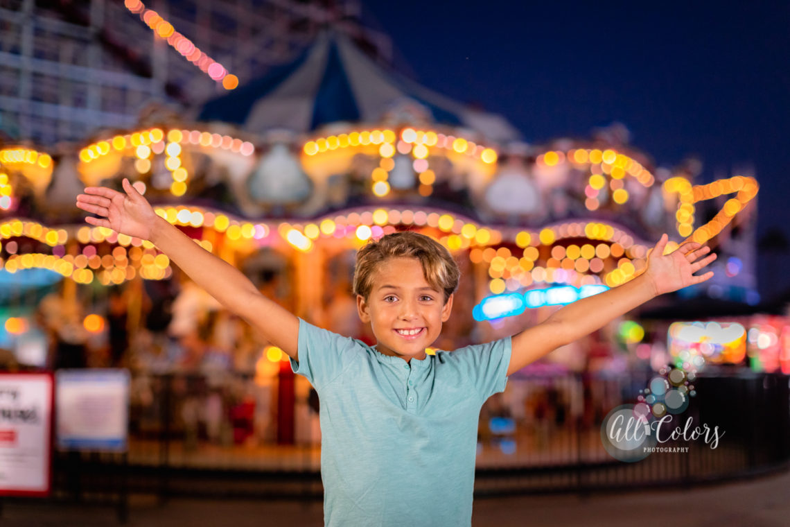 child in front of a carrousel in San Diego