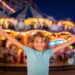 child in front of a carrousel in San Diego