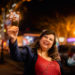 Happy woman holding a sparkler on the street
