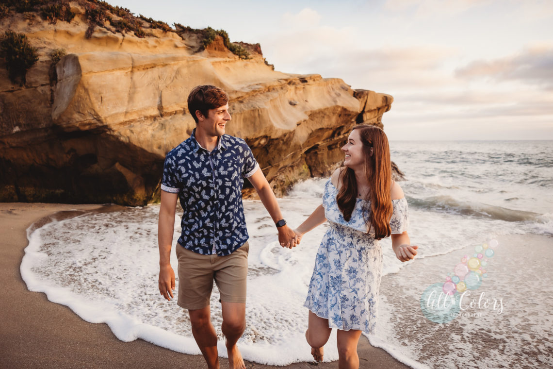 happy couple holding hands at the beach in California